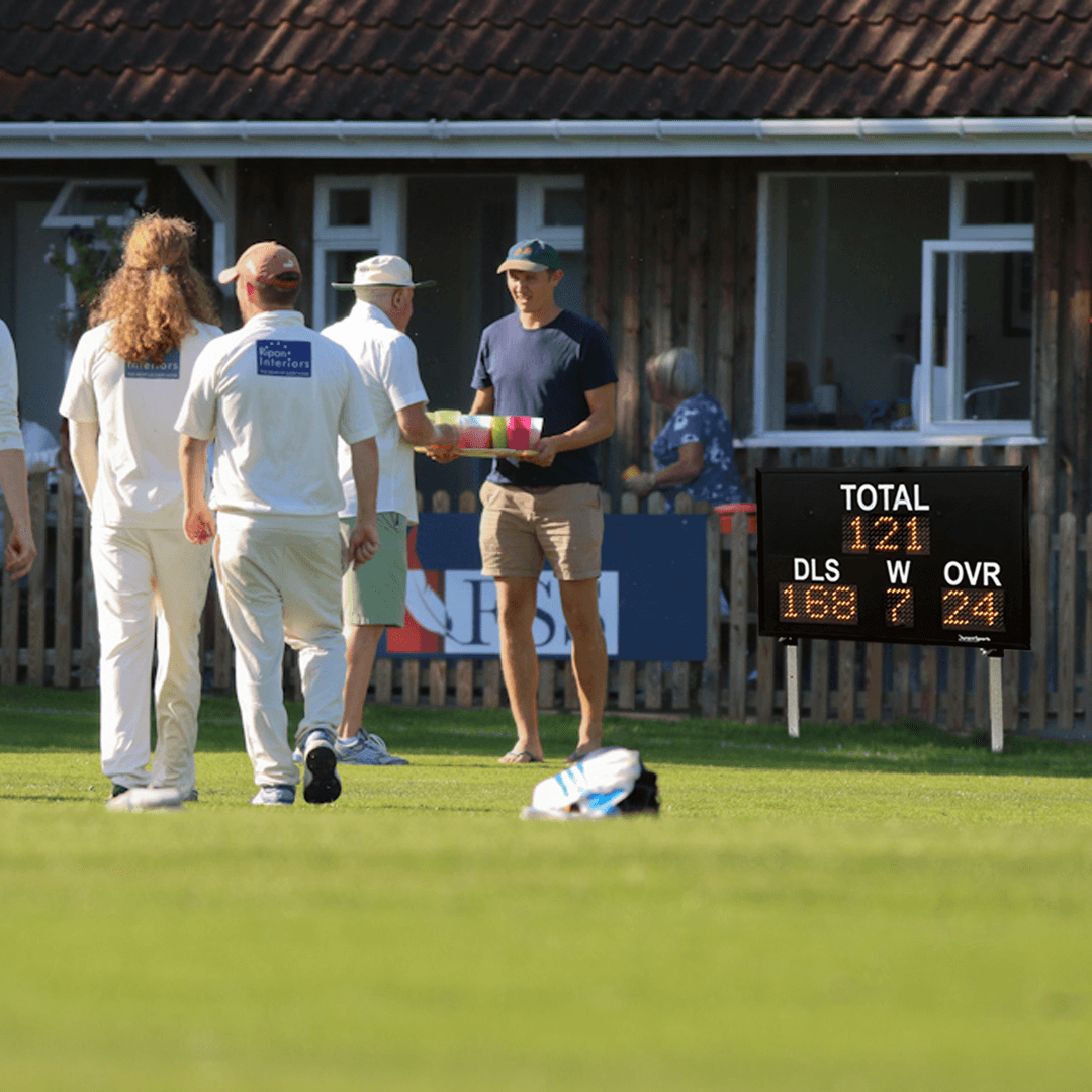 DC9 6" Repeater DLS displaying scores during a cricket match with players in action.