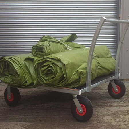 Flat Sheet Trolley loaded with green sheets on a galvanised steel bed, featuring puncture-proof wheels.