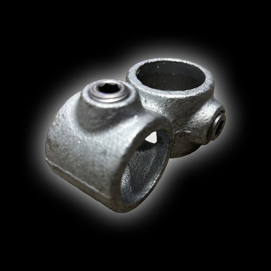 Two galvanized steel pipe clamps with screws on a black background