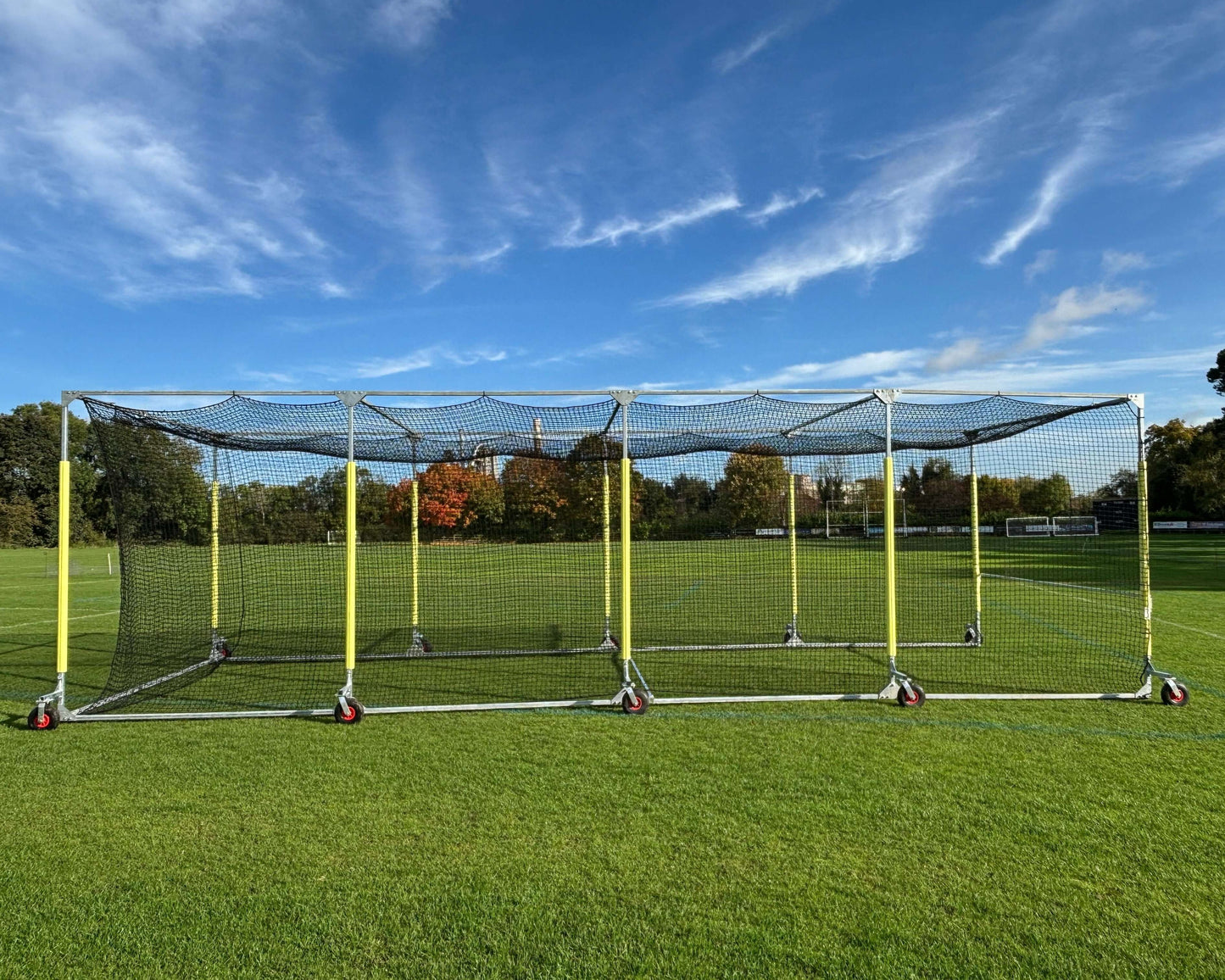 11m Anti-Vermin Mobile Batting Cage in a grassy field under a clear blue sky.
