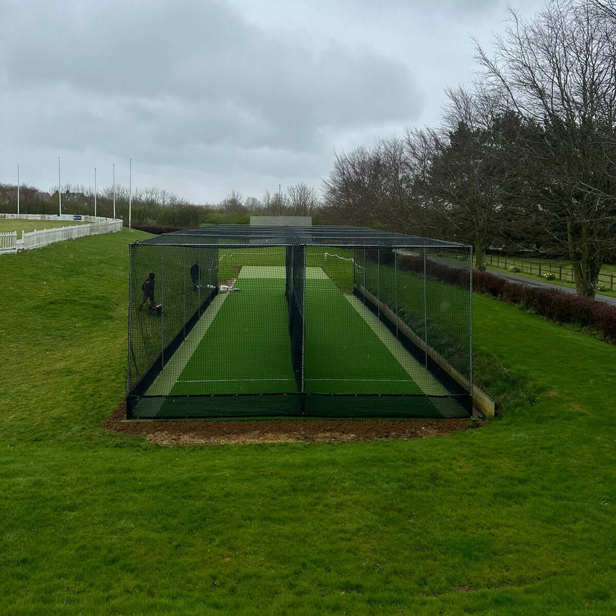 50m x 500mm Anti Vermin Skirt used around a mobile cricket cage on a grassy field.