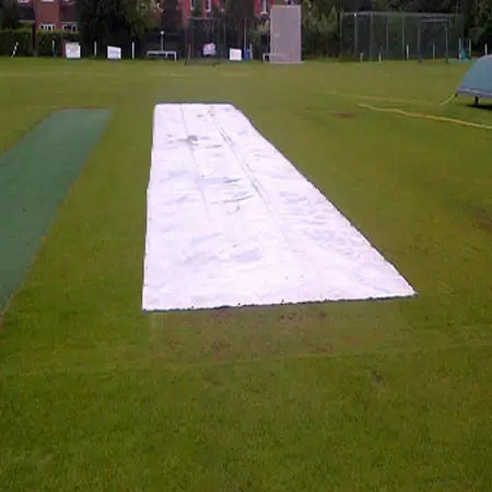 Flat Sheet 210gsm laid out on cricket field, providing protection for the pitch.