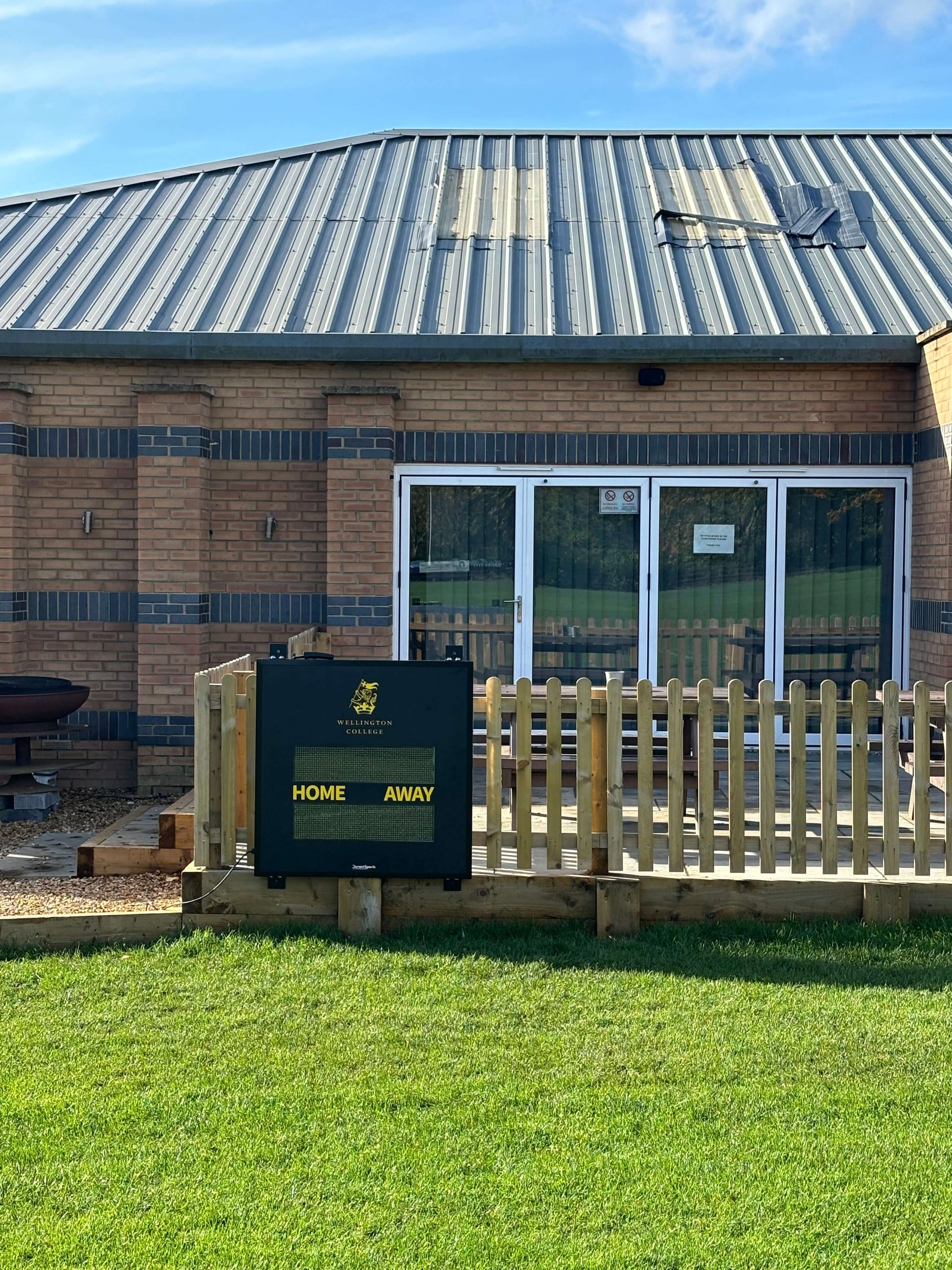 Multi-Sport Scoreboard displayed outside a building, showing HOME and AWAY categories in clear visibility.