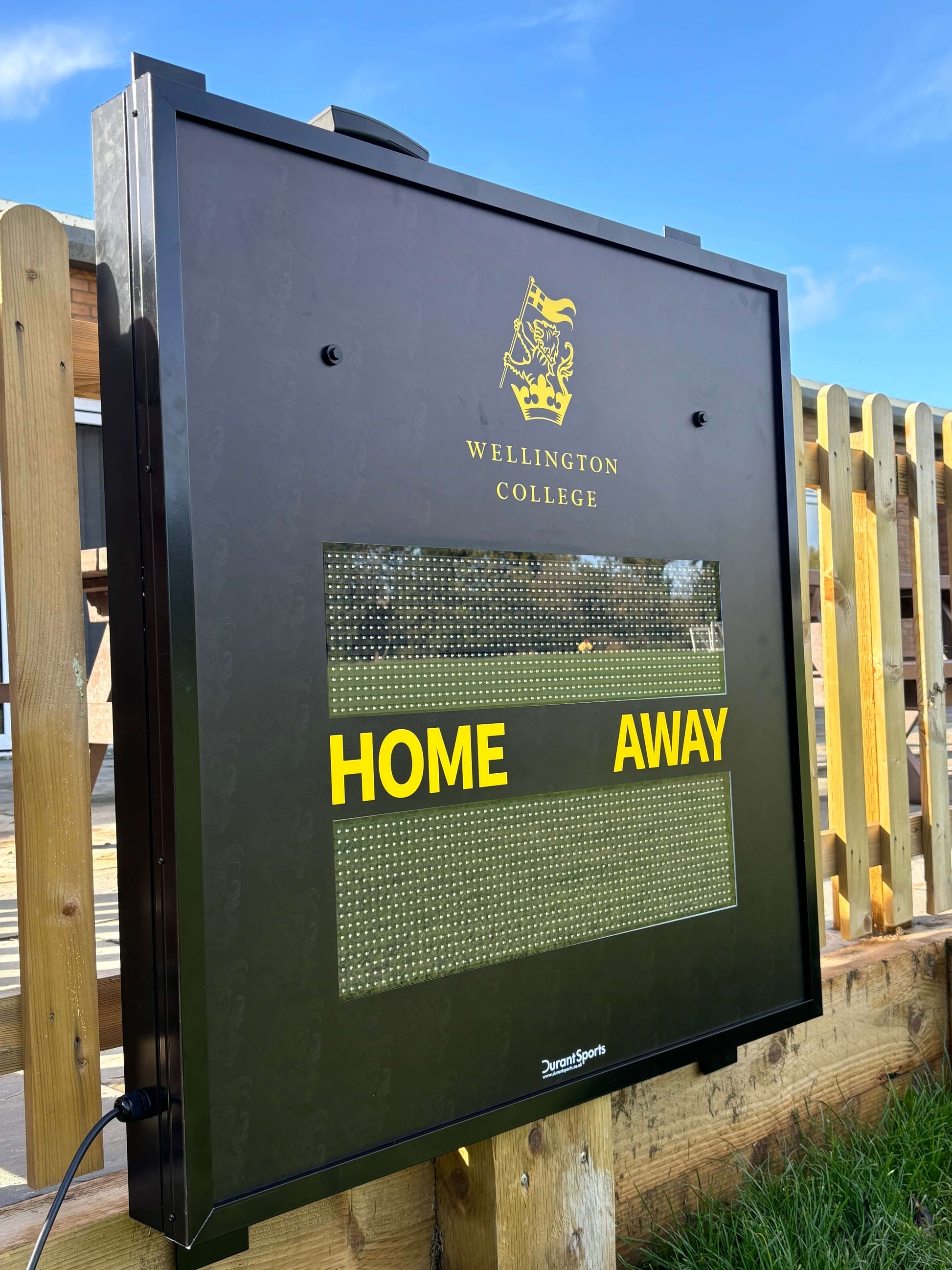 Multi-Sport Scoreboard displayed at Wellington College showing HOME and AWAY sections.
